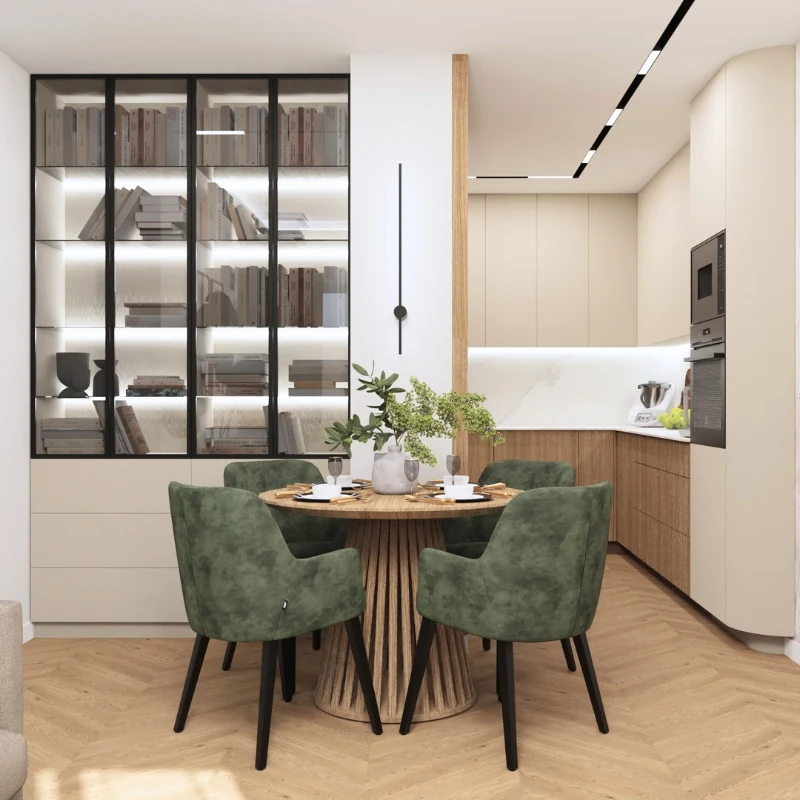 Stylowa jadalnia z okrągłym stołem i zielonymi krzesłami, obok kuchnia z nowoczesnymi meblami.